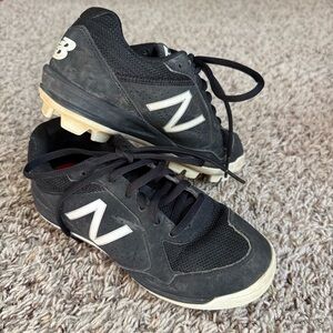 New Balance Kids' All-Star baseball cleats in black and white size 1.5